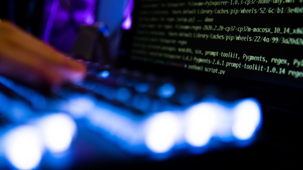 A person types at a backlit keyboard arranged in Danbury, U.K., on Thursday, Jan. 7, 2021. In the spring, hackers managed to insert malicious code into a software product from an IT provider called SolarWinds Corp., whose client list includes 300,000 institutions.