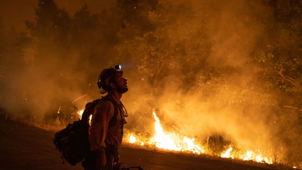 A firefighter monitors a fire during the Mosquito Fire near Foresthill, California, US, on Wednesday, Sept. 7, 2022. A wildfire burning in the Tahoe National Forest exploded Wednesday afternoon prompting evacuation orders near Foresthill.
