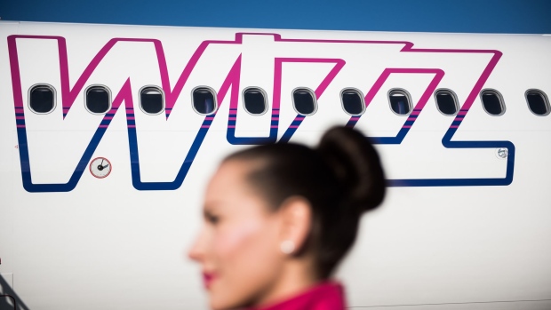 A logo sits on the body of an Airbus A321-231 passenger aircraft, operated by Wizz Air Holdings Plc, at Liszt Ferenc airport in Budapest, Hungary, on Monday, Jan. 9, 2017. Wizz Air, the No. 1 no-frills carrier in Eastern Europe, grew passenger numbers 19 percent to 23 million as it added more destinations in the west of the continent. Photographer: Akos Stiller/Bloomberg