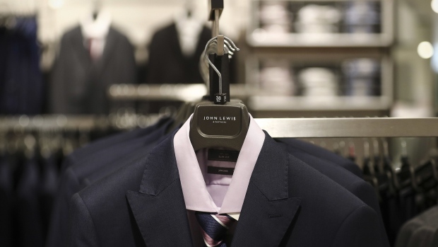 A shirt and blazer hangs from a branded clothes hanger in the menswear department inside a John Lewis Partnership Plc department store in London, U.K., on Thursday, July 23, 2020. U.K. Prime Minister Boris Johnson had resisted making masks mandatory until July 13, when his government announced that face coverings will be compulsory in stores as of July 24. Photographer: Simon Dawson/Bloomberg