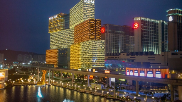The MGM Grand Macau casino, developed by MGM China Holdings Ltd., left, stands illuminated at night in Macau, China, on Tuesday, March 3, 2020. Casinos in Macau, the Chinese territory that's the world’s biggest gambling hub, reported a record drop in gaming revenue, as they grappled with the cost of closing down their businesses for 15 days to help contain the deadly coronavirus outbreak. Photographer: Billy H.C. Kwok/Bloomberg