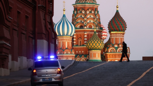 A police car patrols near to Saint Basil's Cathedral on Red square in Moscow, Russia, on Thursday, Feb. 24, 2022. Russian forces attacked targets across Ukraine after President Vladimir Putin ordered an operation to “demilitarize” the country, prompting international condemnation and threats of further punishing sanctions on Moscow, sending markets tumbling worldwide.
