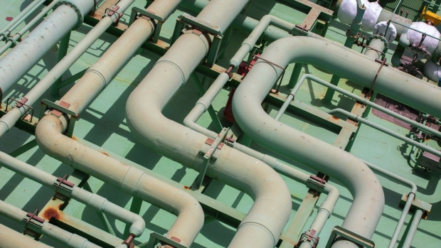 Pipes are seen near a liquefied natural gas (LNG) tank in Japan. Photographer: Bloomberg Creative Photos/Bloomberg