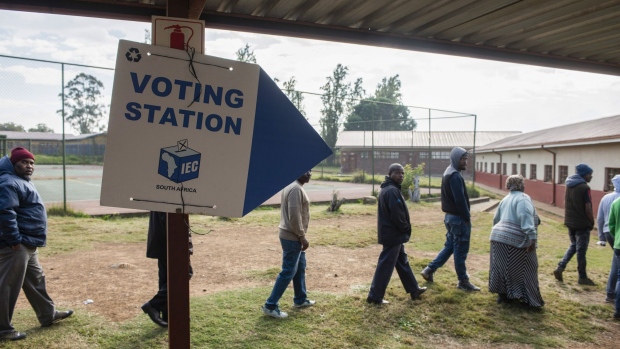 People queue to make their way inside a polling station during the general election in Soweto, South Africa on Wednesday, May 8, 2019. While opinion polls point to the ruling African National Congress extending its quarter-century monopoly on power in Wednesdays vote, South African President Cyril Ramaphosa needs a decisive win to quell opposition in his faction-riven party to push through reforms needed to spur growth in Africas most-industrialized economy.