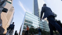 Office workers walk near the Goldman Sachs Group Inc. headquarters in New York, U.S., on Thursday, July 22, 2021. After a year of Zoom meetings and awkward virtual happy hours, New York's youngest aspiring financiers have returned to the offices of the city's investment banks, where they're making the most of the in-person mentoring and networking they've lacked during the pandemic.