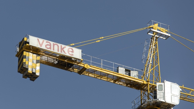 A crane with the China Vanke Co. logo at a residential construction site in the Nanchuan area of Xining, Qinghai province, China, on Tuesday, Sept. 28, 2021. China has urged financial institutions to help local governments stabilize the rapidly cooling housing market and protect the rights of some homebuyers, another signal that authorities are worried about fallout from the debt crisis at China Evergrande Group. Photographer: Qilai Shen/Bloomberg