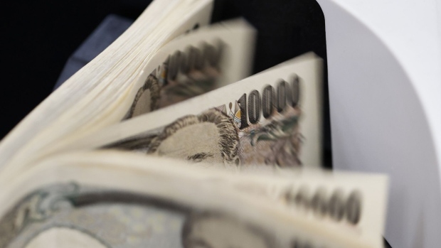 Japanese 10,000 yen banknotes in a currency counting machine arranged at a branch of Resona Bank Ltd. in Tokyo, Japan, on Tuesday, Aug. 9, 2022. Dollar-yen, which soared 38% from a March 2020 trough to mid-July this year, is in retreat. Photographer: Kiyoshi Ota/Bloomberg