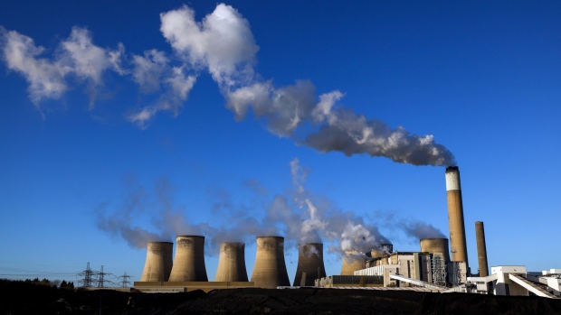 Piles of coal next to cooling towers at Uniper SE's coal-fired power station in Ratcliffe-on-Soar, U.K., on Thursday, Dec. 2, 2021. The recent drop in prices for coal and U.S. gas, as well as limited interest for LNG cargoes from some buyers in Asia, opened the way for added supply into Europe.