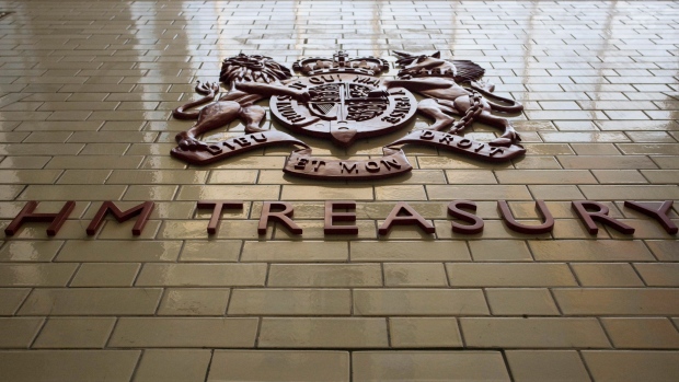 The HM Treasury logo sits in display inside the building in Whitehall, in London, U.K., on Wednesday, Oct. 20, 2010. Chancellor of the Exchequer George Osborne and Treasury Chief Secretary Danny Alexander, will detail his plan in Parliament today to virtually eliminate the 156 billion-pound ($245 billion) deficit by 2015. Photographer: Bloomberg/Bloomberg