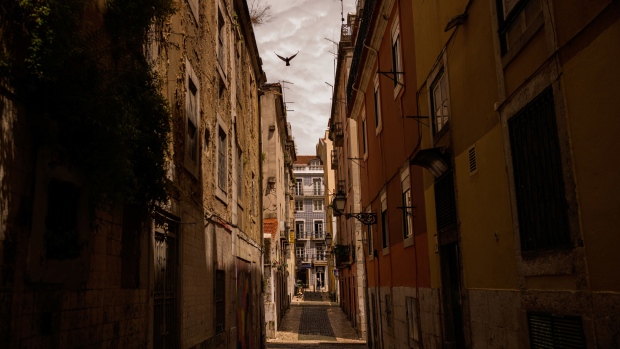 Residential buildings stand along a deserted street in the Bairro Alto neighbourhood in Lisbon, Portugal on Thursday, May 14, 2020. The European Union’s executive arm pushed for a continent-wide revival of tourism with a series of policy recommendations for EU countries as they loosen lockdowns triggered by the coronavirus pandemic.