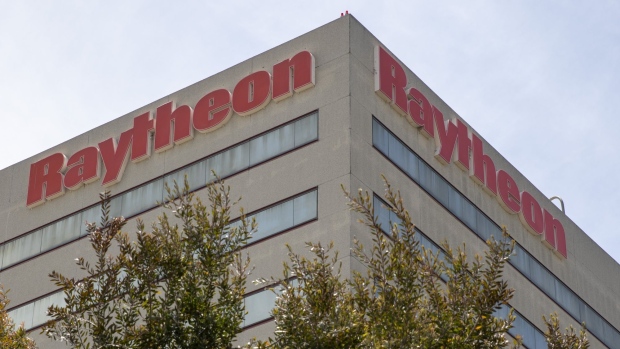Signage is displayed outside a Raytheon Co. defense building in El Segundo, California, U.S., on Monday, June 10, 2019. United Technologies Corp. agreed to buy Raytheon in an all-stock deal, forming an aerospace and defense giant with $74 billion in sales in one of the industrys biggest transactions ever. Photographer: Kyle Grillot/Bloomberg