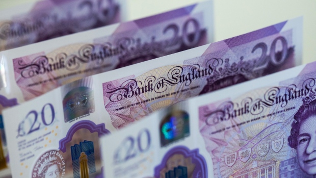 British twenty pound notes stand in this arranged photograph in Danbury, U.K., on Monday, March 23, 2020. The pound rose, boosted by broad dollar weakness, after the U.K. government banned all unnecessary movement of people for at least three weeks in order to reduce the spread of coronavirus.