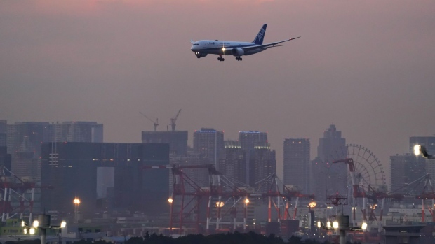 An aircraft operated by All Nippon Airways Co. (ANA) approaches Haneda Airport in Tokyo, Japan, on Sunday, July 31, 2022. All Nippon Airways is scheduled to release its earnings figures on Aug. 1.