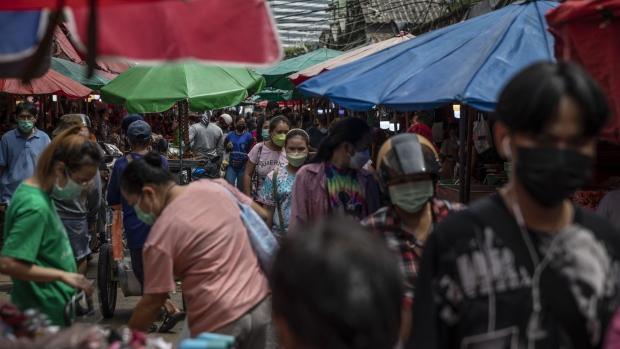 Customers shop at a wet market in Bangkok, Thailand, on Saturday, July 2, 2022. Foreign tourist arrivals into Thailand are set to beat official forecasts with the lifting of pandemic-era restrictions, a rare positive for the nation’s Covid-battered economy and currency. Photographer: Andre Malerba/Bloomberg