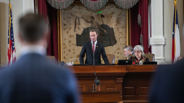 Dade Phelan (R-TX) (C) listens to U.S. Rep. Will Metcalf (R-TX) (L) move to issue a call of the House to try to regain a quorum on July 13, 2021 in Austin, Texas.