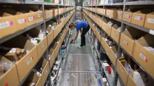 A worker scans an inventory barcode ready to pick an order in the storage area at the Ozon.ru fulfillment center in Tver, Russia, on Tuesday, July 30, 2019. Russian e-commerce platform Ozon.ru's two largest shareholders extended 10 billion rubles ($154 million) in financing this year, signaling faith in the Amazon-style market's expansion even as the economy slows and Baring Vostok partners fight charges related to a dispute at another investment in the country.