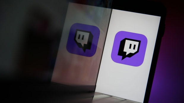 A smartphone displays a logo for the Twitch streaming app, operated by Amazon.com Inc., in this arranged photograph in London, U.K., on Thursday, Sept. 17, 2020. Twitch is still by far the largest livestreaming site, with 1.4 billion hours watched in July, up 67% year over year, according to StreamElements and Arsenal.gg.