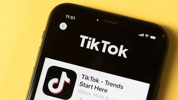 The download page for ByteDance Ltd.'s TikTok app is arranged for a photograph on a smartphone in Sydney, New South Wales, Australia, on Monday, Sept. 14, 2020. Oracle Corp. is the winning bidder for a deal with TikTok’s U.S. operations, people familiar with the talks said, after main rival Microsoft Corp. announced its offer for the video app was rejected. Photographer: Brent Lewin/Bloomberg