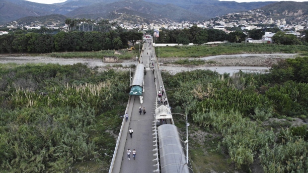 Pedestrians cross the Simon Bolivar International Bridge as it reopens near the Colombian border in Tachira, Venezuela, on Sunday, Aug. 7, 2022.