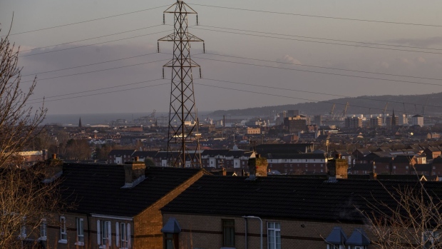 Electrical power lines hang from a transmission pylon among houses looking towards Belfast Harbour in Belfast, Northern Ireland, U.K., on Friday, Jan. 3, 2020. With the U.K. due to leave the European Union, questions remain over trading agreements and Ireland's 12-year-old single electricity market, known as the SEM.
