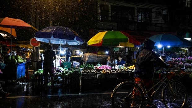 Street food vendors wait for customers during a rainfall in Yangon, Myanmar on September 13. Photographer: Sai Aung Main/AFP/Getty Images