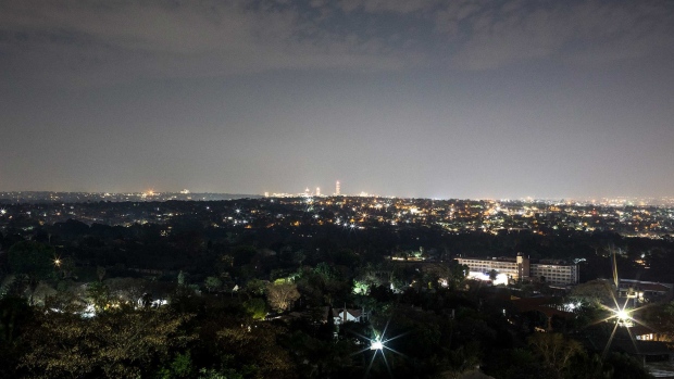 A view of Johannesburg shows Sandton, Africa’s richest square mile, on the horizon. But suburbs on the left and foreground remain in darkness. Photographer: Ilan Godfrey/Bloomberg