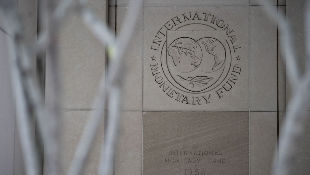 Signage hangs at the International Monetary Fund (IMF) headquarters in Washington, D.C., U.S., on Tuesday, April 14, 2020. In its first World Economic Outlook report since the spread of the coronavirus and subsequent freezing of major economies, the IMF estimated today that global gross domestic product will shrink 3% this year.