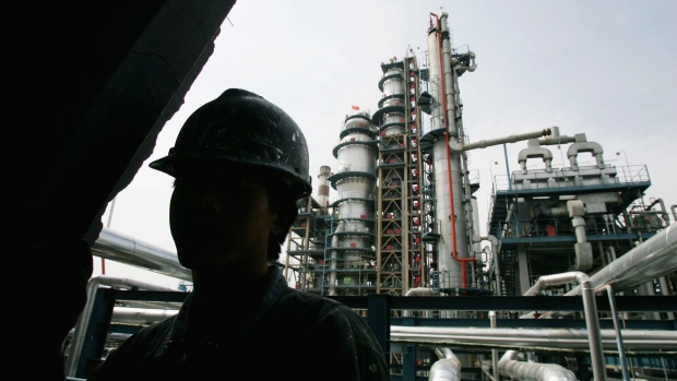 LUOCHUAN COUTY, CHINA - MAY 25: An employee works at the Yanlian Oil Refinery May 25, 2005 in Luochuan County, Shaanxi Province, China. About 50 percent of China's oil and natural gas supply will be imported by 2020 due to the growing gap between domestic demand and production, according to the Xinhua news agency. As China's domestic production of oil has failed to keep up with booming economic growth and demand from the auto market, the country has been trying to gain access to foreign supplies of oil and natural gas, the report said. China produced 175 million tons of crude oil last year. (Photo by Andrew Wong/Getty Images)