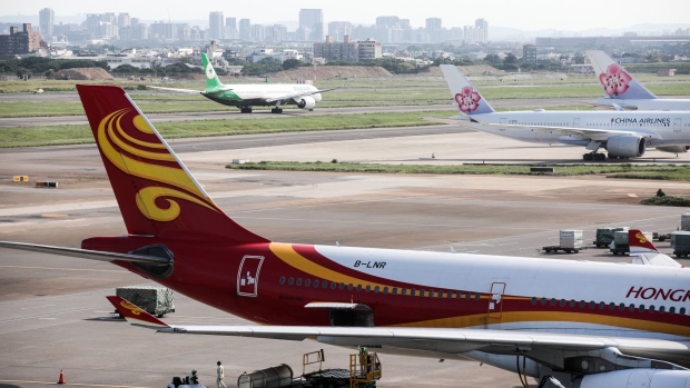 Aircraft operated by Hong Kong Airlines Ltd. and China Airlines Ltd. sit on the tarmac at Taiwan Taoyuan International Airport in Dayuan District, Taoyuan, Taiwan, on Wednesday, Sept. 23, 2020. Taiwan will be among the most pressing security issues facing whoever wins the U.S. election on Nov. 3.