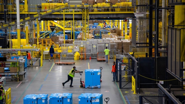A worker pushes a pallet at an Amazon fulfillment center on Cyber Monday in Robbinsville, New Jersey, U.S., on Monday, Nov. 29, 2021. Adobe Digital Economy Index is expecting Cyber Monday to bring the biggest holiday shopping of the year, with consumers projected to spend between $10.2 billion and $11.3 billion.