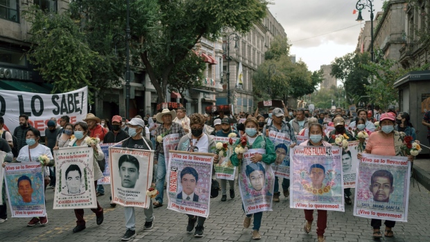 Demonstrators during a rally on the anniversary of the 2014 mass kidnapping of Ayotzinapa students in Mexico City, Mexico, on Monday, Sept. 26, 2022. The Mexican army's role in the disappearance of 43 college students, its participation in covering up the facts and its alleged links to organized crime are now at the center of a case that has shaken the nation, reports the Associated Press.