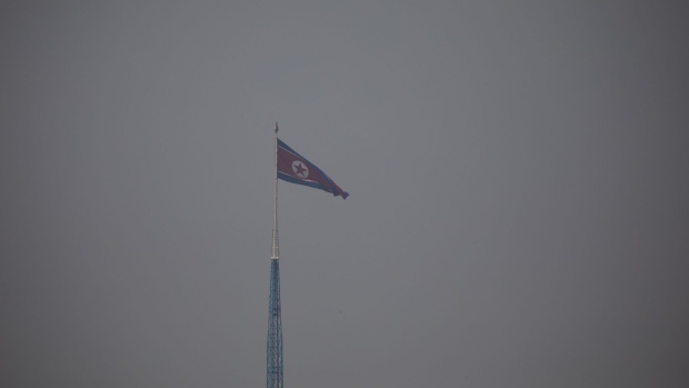 A North Korean flag flying above North Korea's Gijungdong village during a media tour of Daeseong-dong village in the Demilitarized Zone (DMZ) of Paju, South Korea, on Monday, Sept. 30, 2019. KT Corp., the largest telecommunication company in South Korea, began providing 5G network service to the village in June. Photographer: SeongJoon Cho/Bloomberg