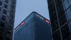 Logos sit illuminated on the HSBC Holdings Plc headquarter skyscraper offices in the Canary Wharf business, financial and shopping district in London.