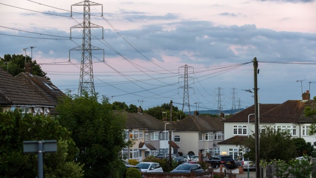 Electricity transmission towers near residential houses in Upminster, UK, on Monday, July 4, 2022. The UK is set to water down one of its key climate change policies as it battles soaring energy prices that have contributed to a cost-of-living crisis for millions of consumers.