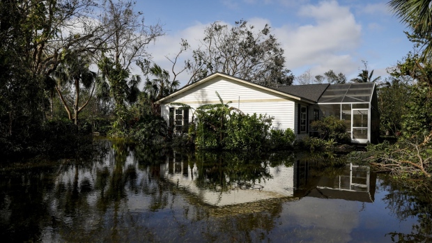 A flooded house following Hurricane Ian in Fort Myers, Florida, US, on Thursday, Sept. 29, 2022. Hurricane Ian, one of the strongest hurricanes to hit the US, weakened to a tropical storm but continues to dump rain on the state as it makes its way up the US Southeast.
