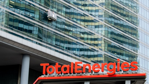 Signage for TotalEnergies SE at the company's electric vehicle charging station in the La Defense business district in Paris, France, on Thursday, July 28, 2021. TotalEnergies will extend its $2 billion buyback program into the third quarter after profit surged to a record, propelled by surging gasoline prices and soaring demand for natural gas in Europe.