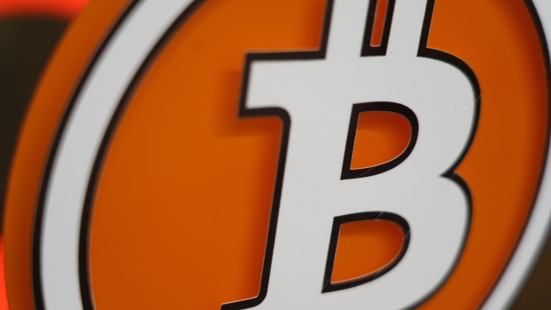 The logo of Bitcoin on the window of a cryptocurrency automated teller machine (ATM) kiosk in Warsaw, Poland, on Tuesday, May 24, 2022. A dramatic increase in the size and complexity of crypto markets means the sector is on track to become a risk for financial stability that must urgently be regulated, the European Central Bank said. Photographer: Piotr Malecki/Bloomberg
