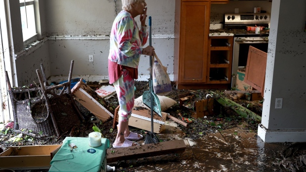 A resident begins cleaning up after Hurricane Ian in Punta Gorda, Florida, on Sept. 29, 2022. Photographer: Win McNamee/Getty Images North America