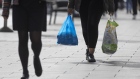 Shoppers carry plastic shopping bags in Croydon, Greater London, UK, on Monday, Sept. 26, 2022. The Bank of England may need to step in with an emergency rate rise to calm market nerves about the government’s economic plans, Conservative lawmakers said after the pound tumbled to a record low against the dollar. Photographer: Jason Alden/Bloomberg