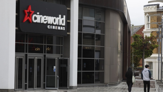Pedestrians pass a Cineworld Group Plc cinema in Aldershot, U.K., on Monday, Oct. 5, 2020. Cineworld said it will temporarily suspend operations at all its American and British movie theaters now that crucial income from winter blockbusters has been pushed into 2021 by the coronavirus pandemic. Photographer: Jason Alden/Bloomberg