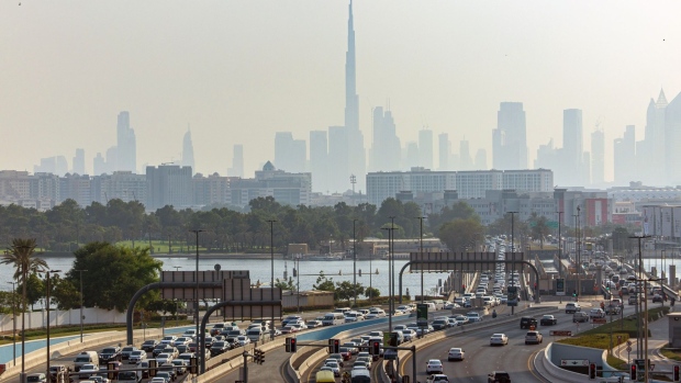 Motorists commute past the Burj Khalifa skyscraper, center, and commercial and residential properties on the city skyline in Dubai, United Arab Emirates, on Thursday, Sept. 15, 2022. Office rents in Dubai are rebounding for the first time in six years, rising faster than in New York or London as global banks and businesses expand into the financial hub known for its love of glitzy construction. Photographer: Christopher Pike/Bloomberg