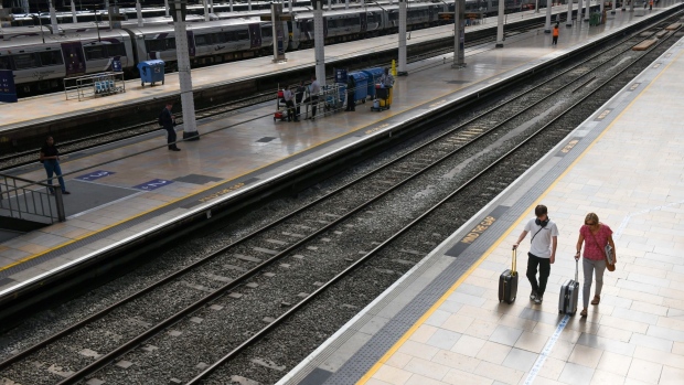 Travellers walk along an empty platform, during the latest round of rail strikes, at London Paddington railway station in London, UK, on Thursday, Aug. 18, 2022. A Network Rail spokesman said there’ll be no services at all on half the system on Thursday and Saturday, slightly less disruptive than during walkouts in July amid improved availability of staff in Scotland. Photographer: Chris J. Ratcliffe/Bloomberg