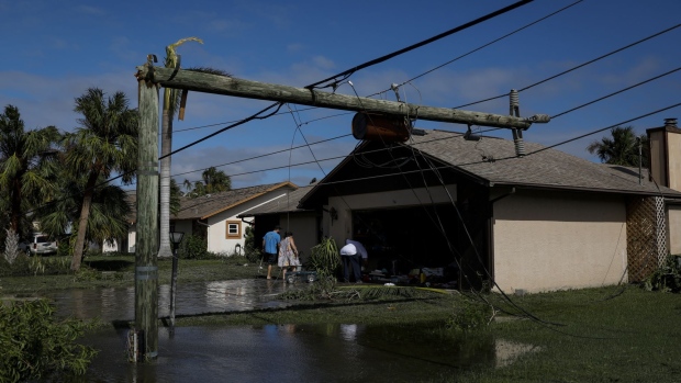 A broken utility pole on a flooded street following Hurricane Ian in Fort Myers, Florida, US, on Thursday, Sept. 29, 2022. Hurricane Ian, one of the strongest hurricanes to hit the US, weakened to a tropical storm but continues to dump rain on the state as it makes its way up the US Southeast.
