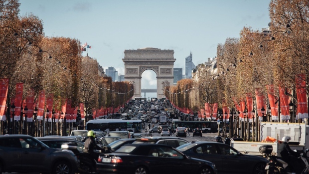 Automobiles in a traffic jam on the Champs Elysee near the Arc de Triomphe on the Champs Elysee ahead of a new curfew in Paris, France, on Tuesday, Dec. 15, 2020. France eased some of its key lockdown measures, while extending other curbs and introducing a new curfew, as the nation continued its fight to get a grip on the coronavirus. Photographer: Cyril Marcilhacy/Bloomberg