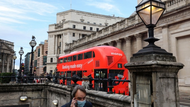 A bus with an advertisement for Monzo Bank Ltd., reading "Banking made easy" passes the Bank of England in the City of London, U.K., on Wednesday, Oct. 20, 2021. The U.K. Treasury is resisting pressure to increase spending in next week's budget because of concern that doing so would backfire by prompting the BOE to raise interest rates more aggressively. Photographer: Hollie Adams/Bloomberg