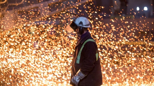 An employee passes the electric arc furnace at Liberty Steel's Aldewerke mill in Rotherham, U.K., on Wednesday, March 21, 2018. Most metals slumped on the London Metal Exchange after U.S. President Donald Trump ordered tariffs on $50 billion worth of imports from China on Thursday, and Beijing announced retaliatory duties shortly afterward. Photographer: Chris Ratcliffe/Bloomberg