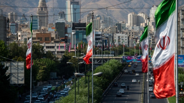National flags of Iran fly above the Modarres highway in Tehran, Iran, on Saturday, Aug. 4, 2018. Iran’s central bank, acting on the eve of U.S. sanctions, scrapped most currency controls introduced this year in a bid to halt a plunge in the rial that has stirred protests against the government of President Hassan Rouhani. Photographer: Ali Mohammadi/Bloomberg