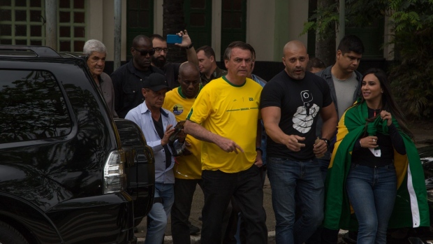 Jair Bolsonaro departs after casting a ballot in Rio de Janeiro. Photographer: Pedro Prado/Bloomberg