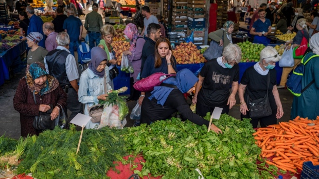 Customers shop at a food market in the Kadikoy district of Istanbul, Turkey. Photographer: Erhan Demirtas/Bloomberg