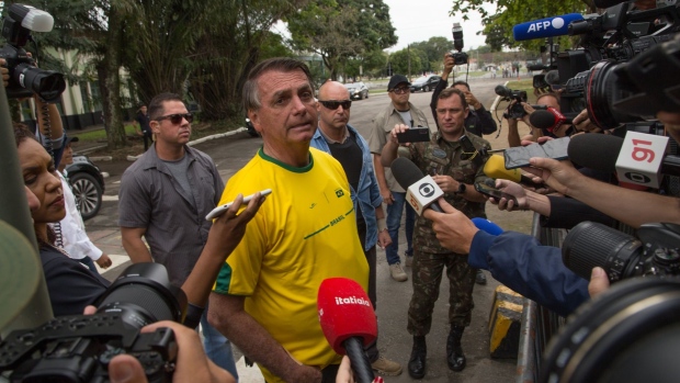 Jair Bolsonaro speaks to members of the media after casting a ballot at a polling station during the presidential elections in Rio de Janeiro, Brazil, on Oct. 2.